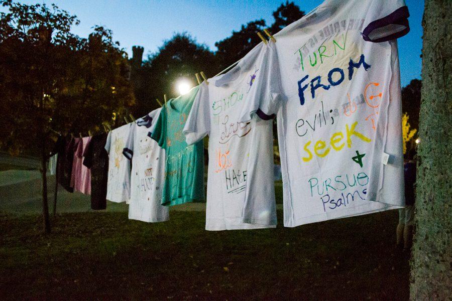 Student-decorated shirts from the Clothesline Project surround Memorial Amphitheater during Take Back the Night. The event addresses sexual violence and offers students information on local services.