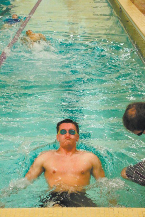 A student on the swim team pushes off the wall preparing for a backstroke during practice. UNA added the swim club this semester and has 47 members.