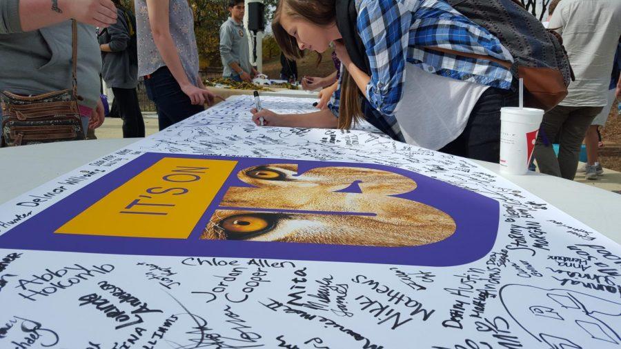 Freshman Sierra Hill signs the “It’s On Us” banner indicating she took the pledge to prevent sexual assault on campus. Student Government President Nick Lang said over 257 students signed the banner Nov. 5.