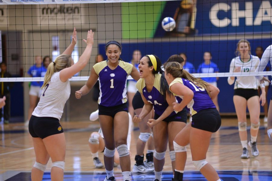 UNAs Ashtyn Kapovich (17), Jessica Austin (1), Andrea De Leon (24) and Sarah Ann Tillery (15) celebrate a point against West Florida in the Gulf South Conference Volleyball Tournament championship match Nov. 22.