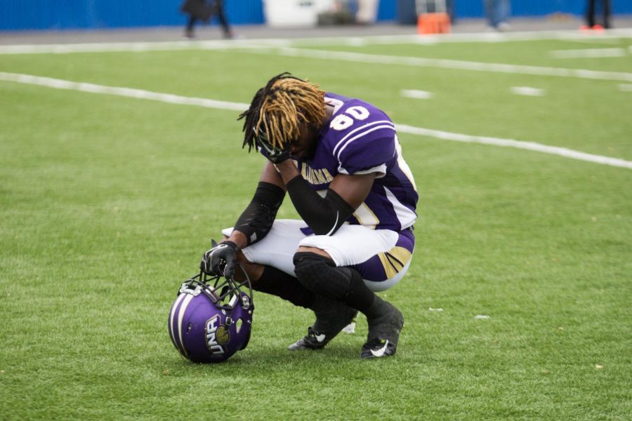 UNA wide receiver Jarret Smith crouches in disappointment after the Lions loss to Tuskegee in the playoffs Nov. 28. The Lions end the season 9-3.