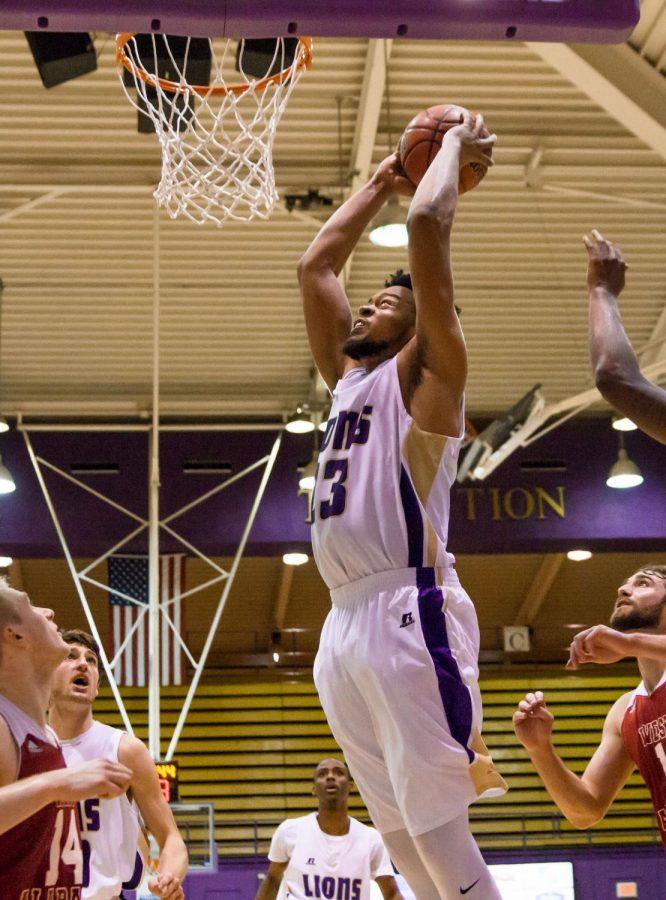 UNA senior forward Bilal Richardson soars to the rim for a dunk against West Alabama. The Lions defeated the Tigers 91-89, as Richardson led the team with 22 points and 17 rebounds.