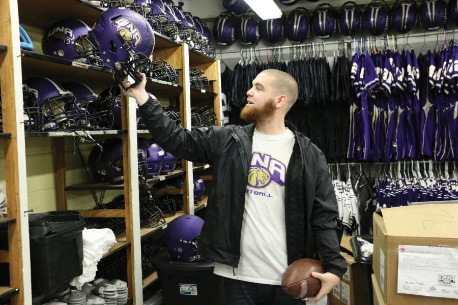 Aubrey Champion, the head equipment manager for the UNA football team, sorts through equipment before the teams spring training session. Champion is one of many student workers in the athletic department.