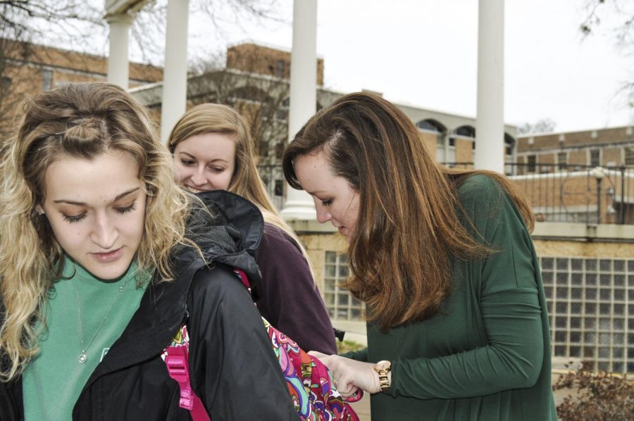 SGA President-elect Sarah Green pins a button on Rachel Huttos backpack as Morgan Smith looks on Feb. 23. Green beat opponent Jose Figueroa-Cifuentes 799-290.