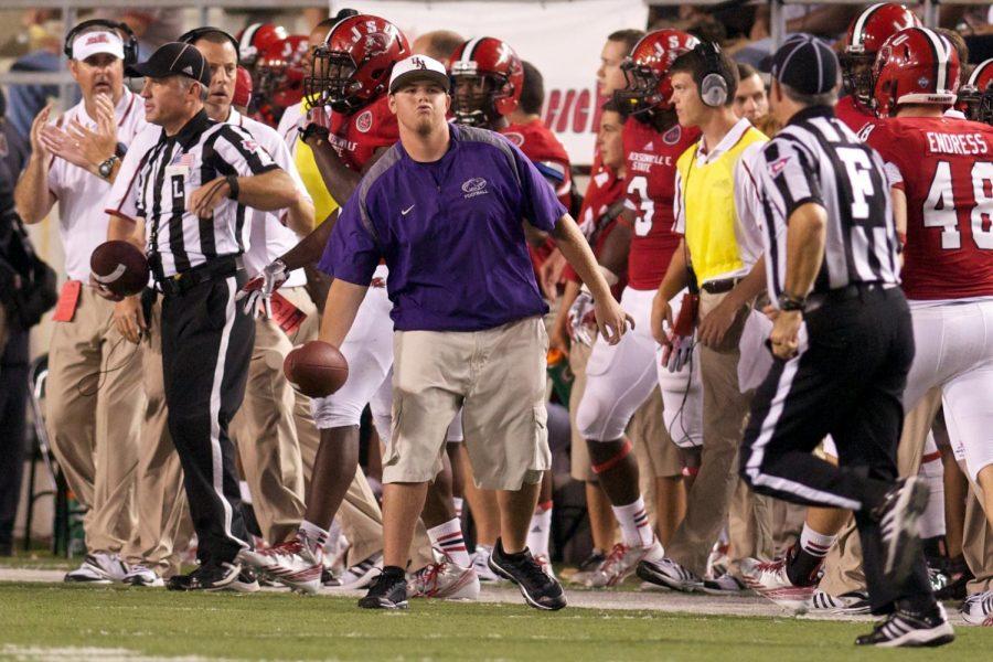 UNA Alumnus John Robert Dawson tosses a football to an official during a game against Jacksonville State in the 2013 season. Dawson works as a clubhouse manager for the St. Louis Cardinals spring training facility in Jupiter, Florida.