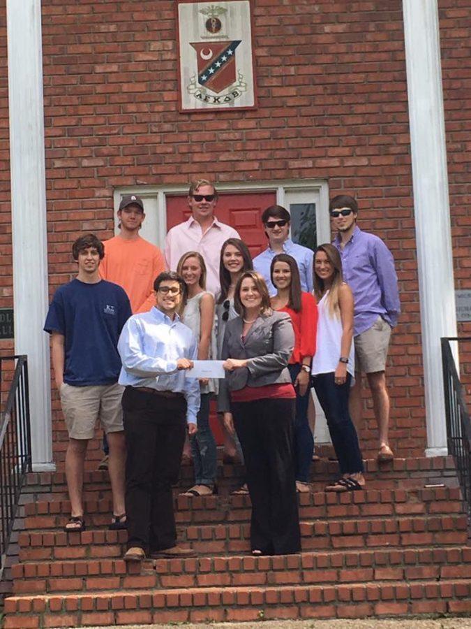 Kappa Sigma Fraternity presents a $3700 check to Executive Director of Safeplace, Inc Rachel Hackworth. “It takes a lot of people and money to make that happen, Hackworth said. Groups that are doing projects like this are certainly heroes to us.”