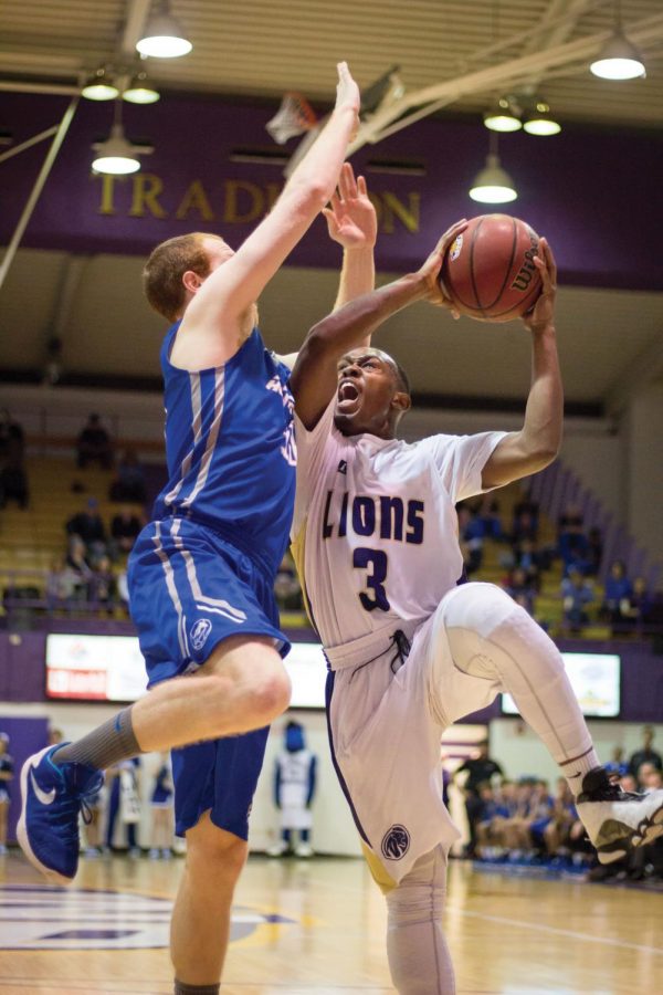 Junior guard Jeff Hodge (right) draws contact during UNA’s 119-103 win against Alabama-Huntsville Jan. 16 in Flowers Hall.