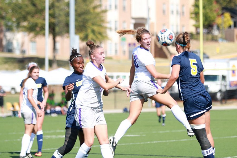 Freshman Haley Yarber (16 white) connects on a header during a conference game against Mississippi College Oct. 16. Yarber scored in the first minute of the game, while Ele Costellos overtime goal gave UNA a 2-1 win.