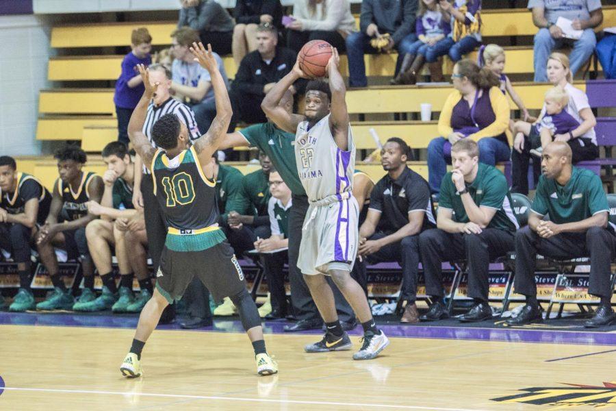 North Alabama sophomore guard Tavaras Tolliver looks to pass the ball on the perimeter in the Lions game against Saint Leo. UNA trailed by six points with under four minutes remaining in regulation, but surged back to force overtime and win the game 101-96.