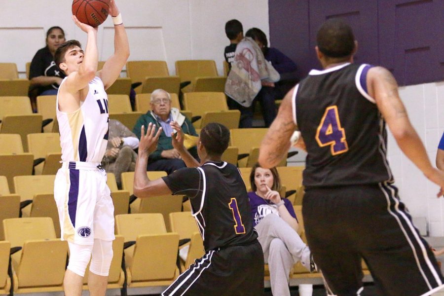 Sophomore forward Dakota Holtzclaw attempts a three point field-goal in North Alabamas home game against Miles Nov. 29. UNA got back in the win column with their 86-74 victory over the Golden Bears.