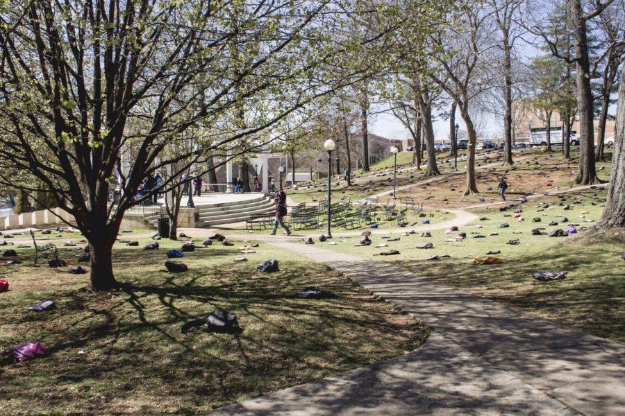 Students examine a display of 1,100 backpacks lining the ground around the Amphitheater March 17. The display is part of the Send Silence Packing event in remembrance of students who have committed suicide and to raise awareness for mental health issues.