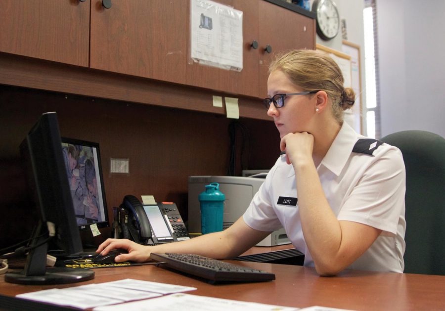 Senior Josie Lott works at a desk in the Willingham Hall Annex ROTC office. Lott has earned several honors and awards during her time in ROTC.