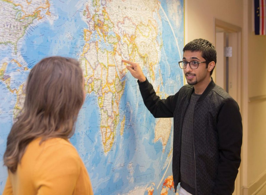 Freshman Abdullah Al Nasser points out his home country of Saudi Arabia to graduate student Hannah Rowe, senior administrative assistant of the Office of International Affairs. Al Nasser is one of the international students who does not go home during holiday breaks.