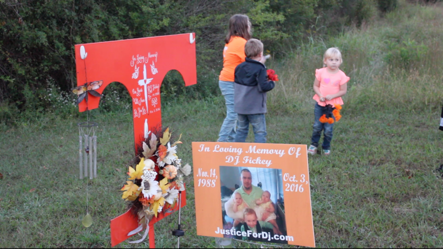 Above is DJ Fickey’s memorial in Walker County, Ga. Amanda Shirley’s daughter, Serena and Fickey’s children, Jack and Paisley wait patiently to decorate it with new flowers. 