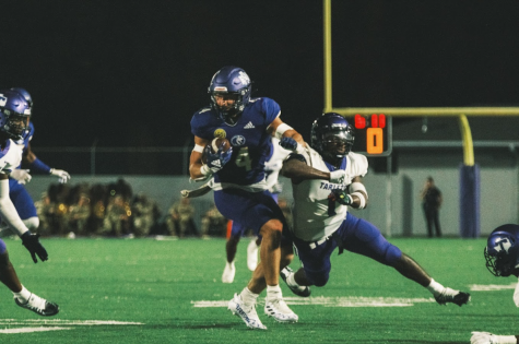 Running back Parker Driggers carries the ball down the field away from Tarleton State (2022).