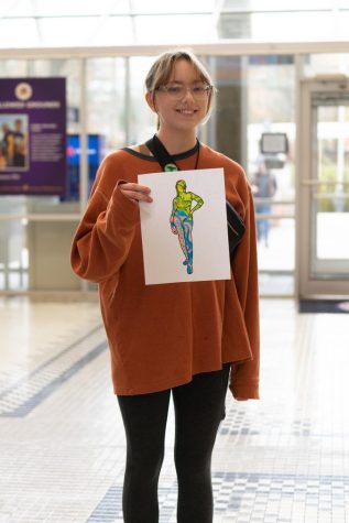A student poses with their body positivity worksheet.