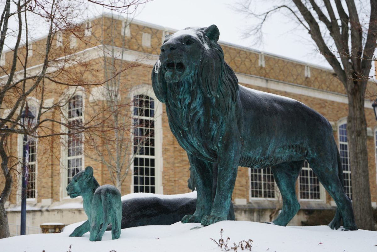 A statue on UNAs campus surrounded by snow.