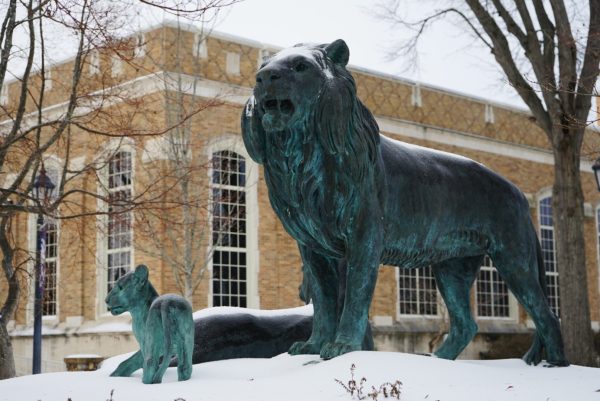 A statue on UNAs campus surrounded by snow.
