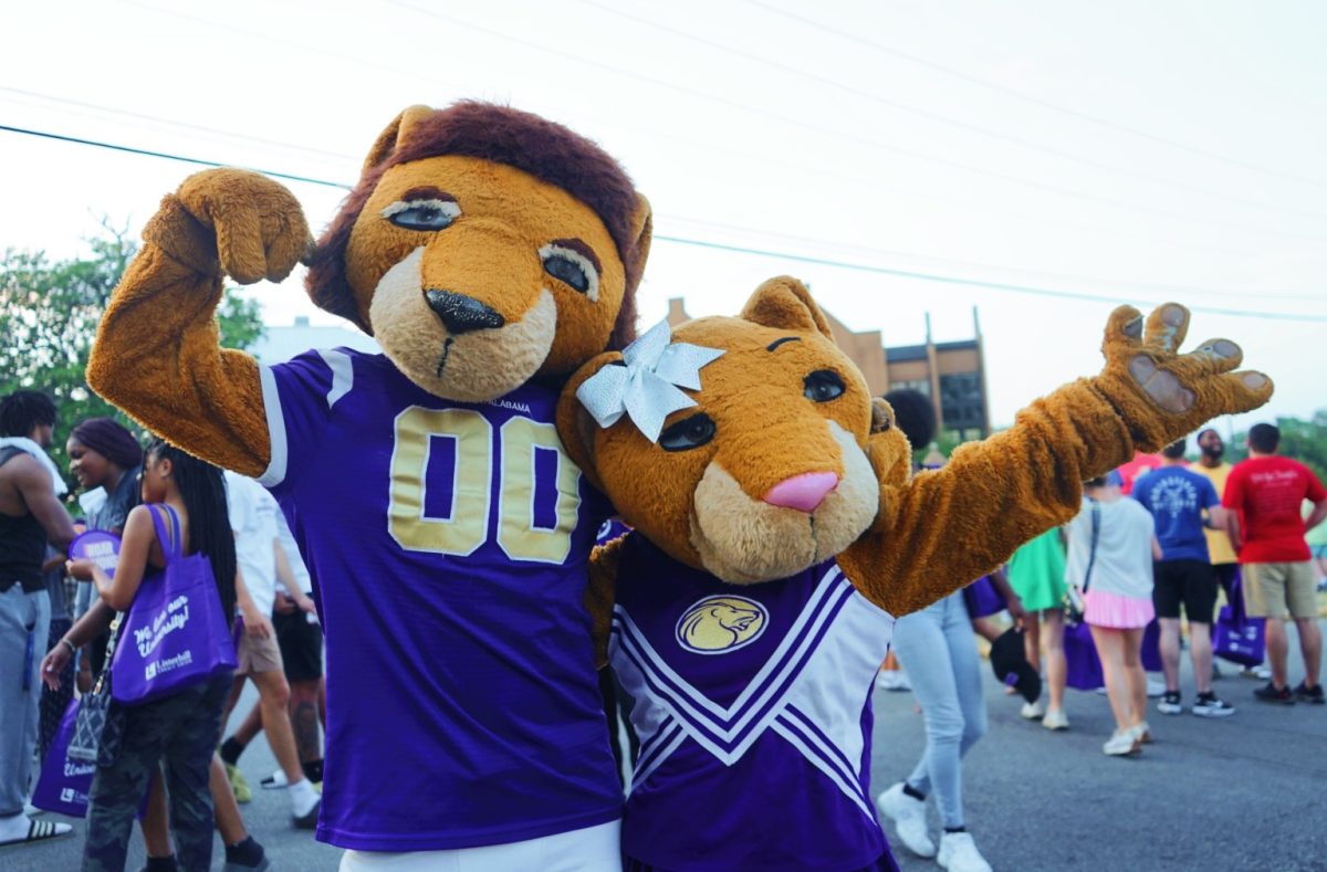 UNA mascots Leo and Una pose for a picture in front of students, who are participating in The Big Deal.