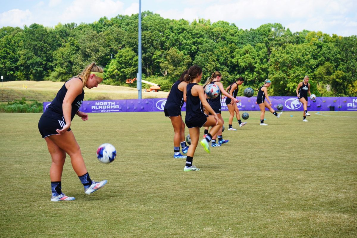 Soccer players practice kick-ups.