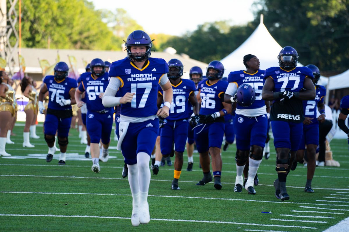 The Football team runs out for their pregame on their home field, Braly Stadium. 