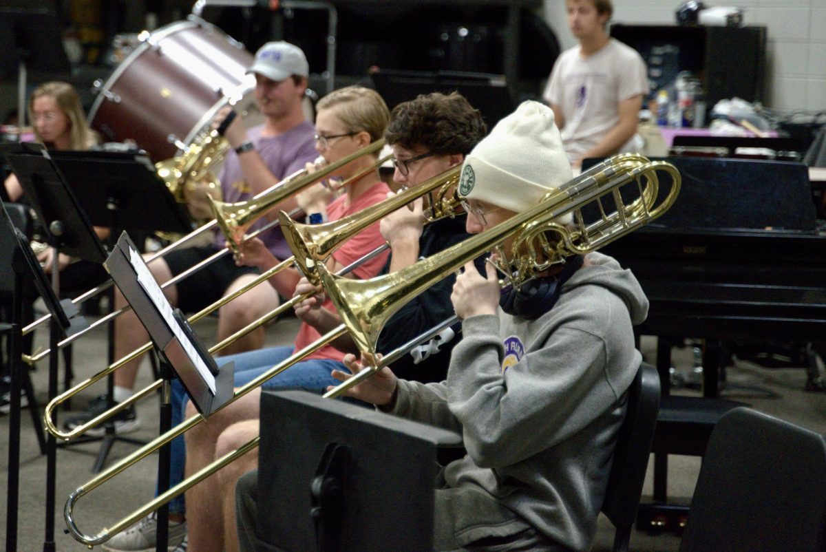 Trombonists rehearse during orchestra practice. 