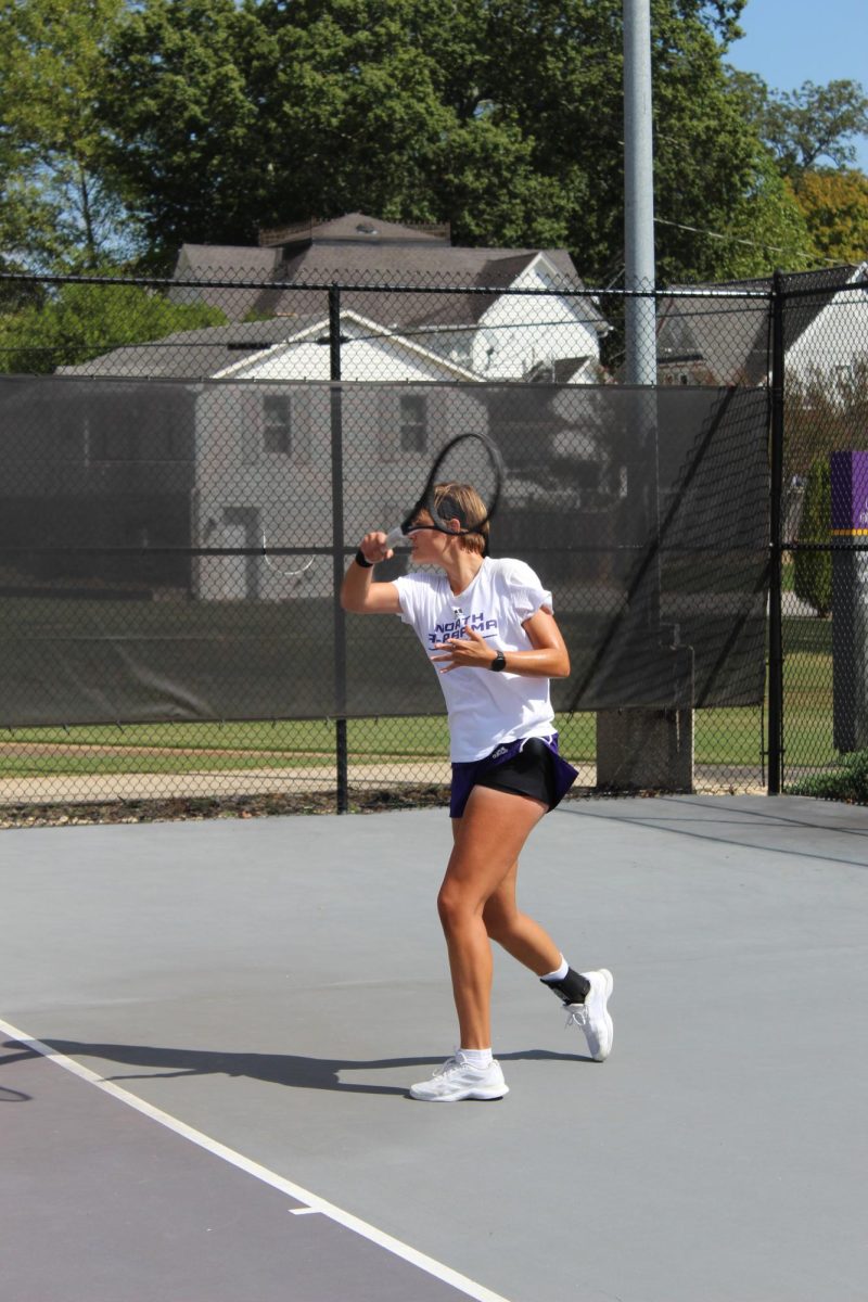 Senior Anoek Pruijmboom hits a tennis ball. 