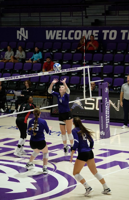 Freshman Kinslee McGowan prepares to set the volleyball to Amelia Keating.