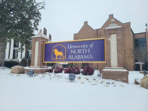 Snow surrounded The University of North Alabama sign. 