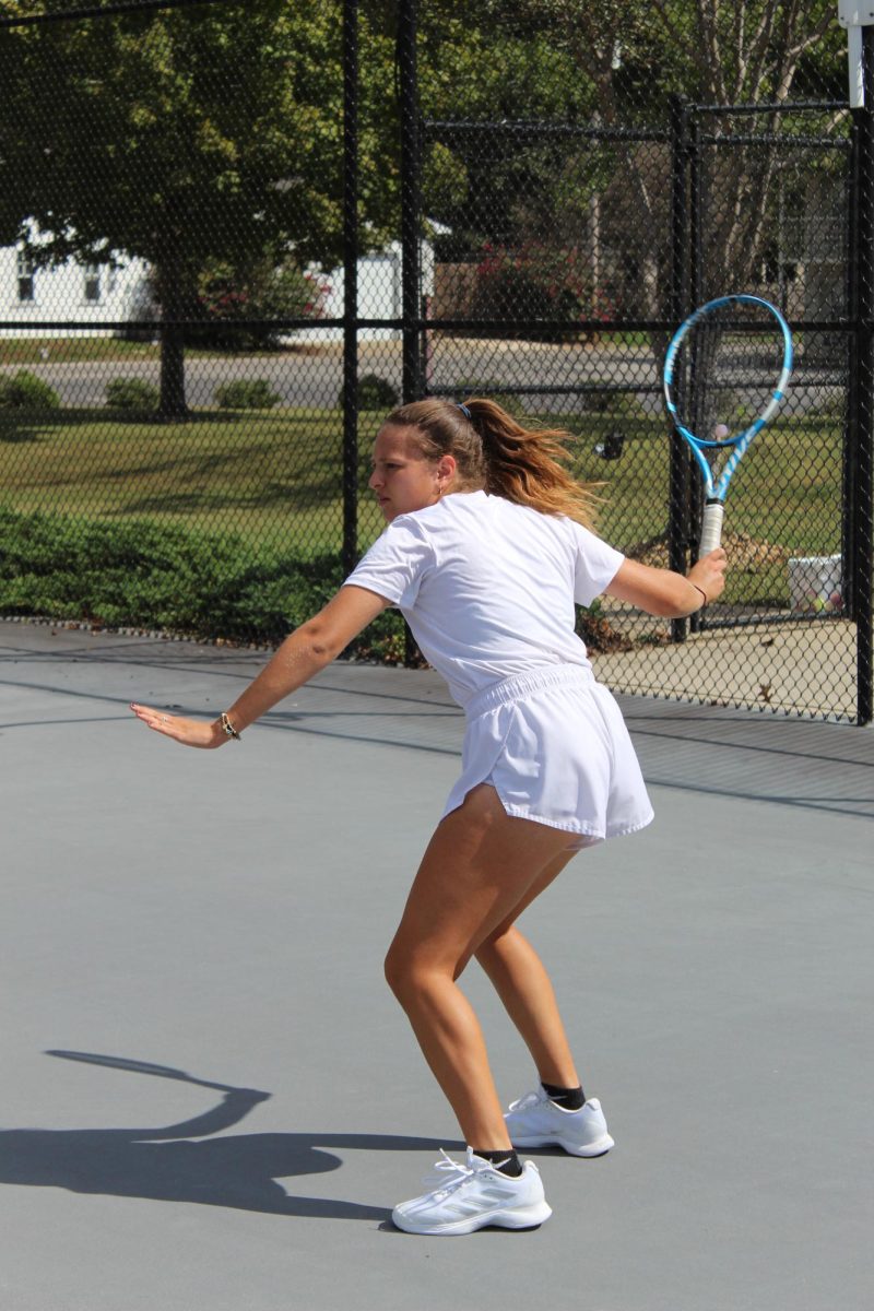 UNA Tennis player prepares to hit a ball in practice. 