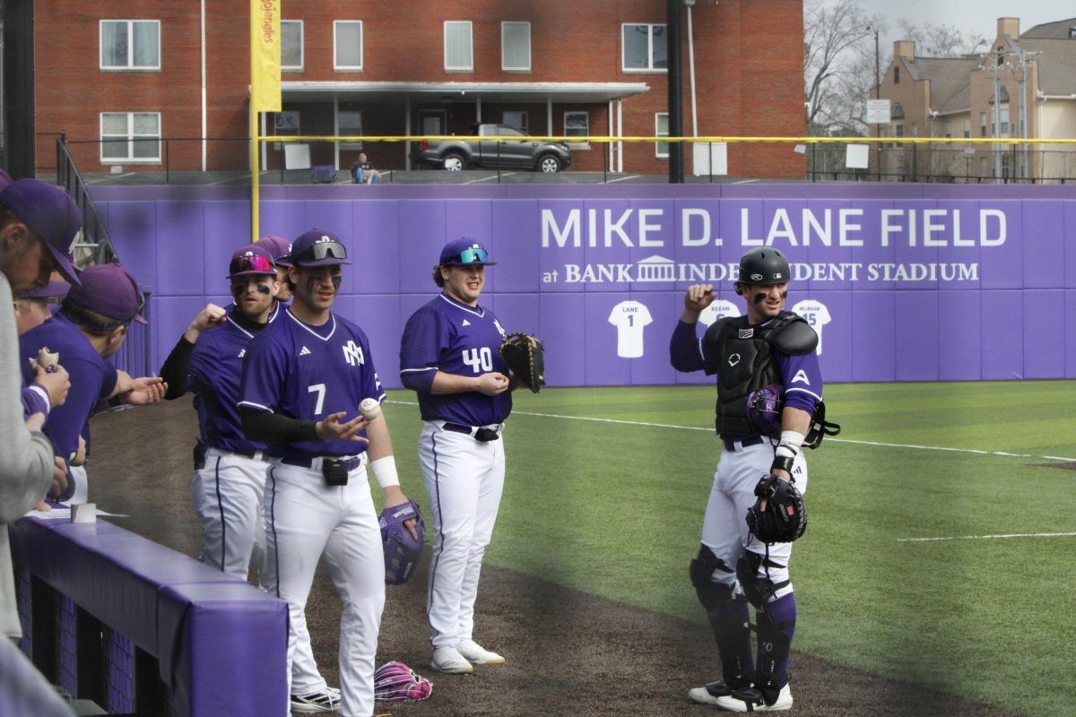 UNA Baseball players stand on the new Mike D. Lane baseball field.